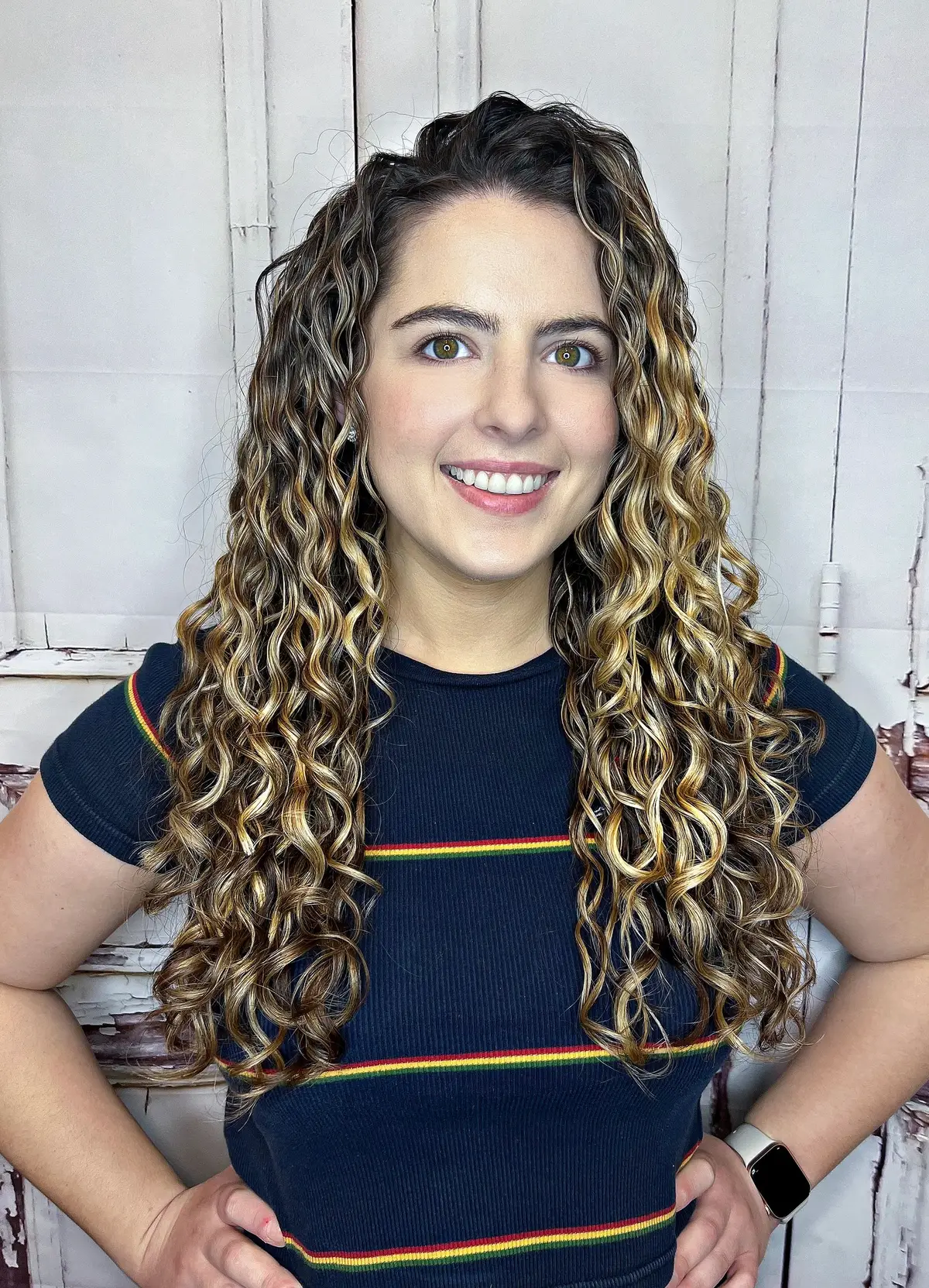 Client with long defined curls after a custom dry cut